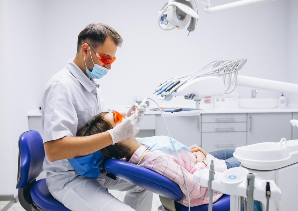 Dentist examining a patient's tooth during an evaluation for tooth nerve pain and possible root canal treatment.