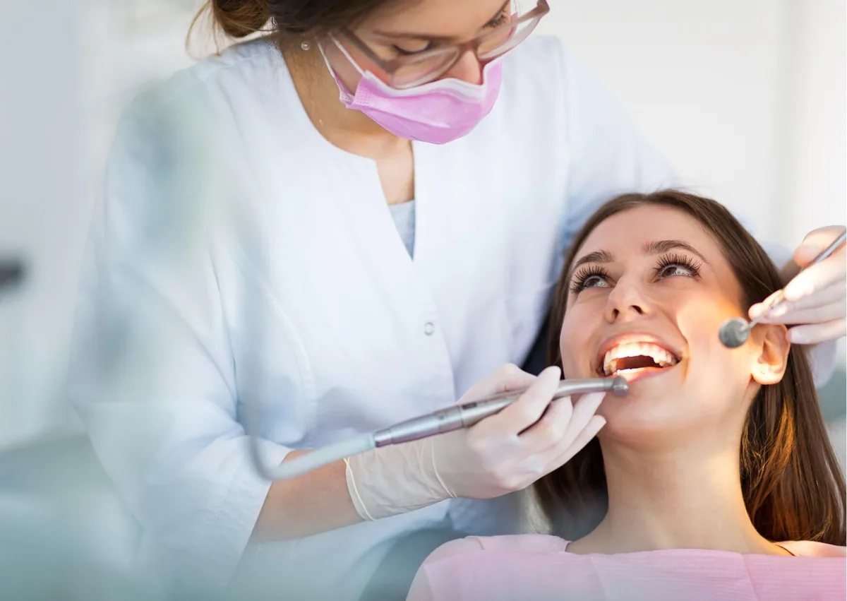 Dentist examining a patient’s mouth to assess the number and condition of their teeth.